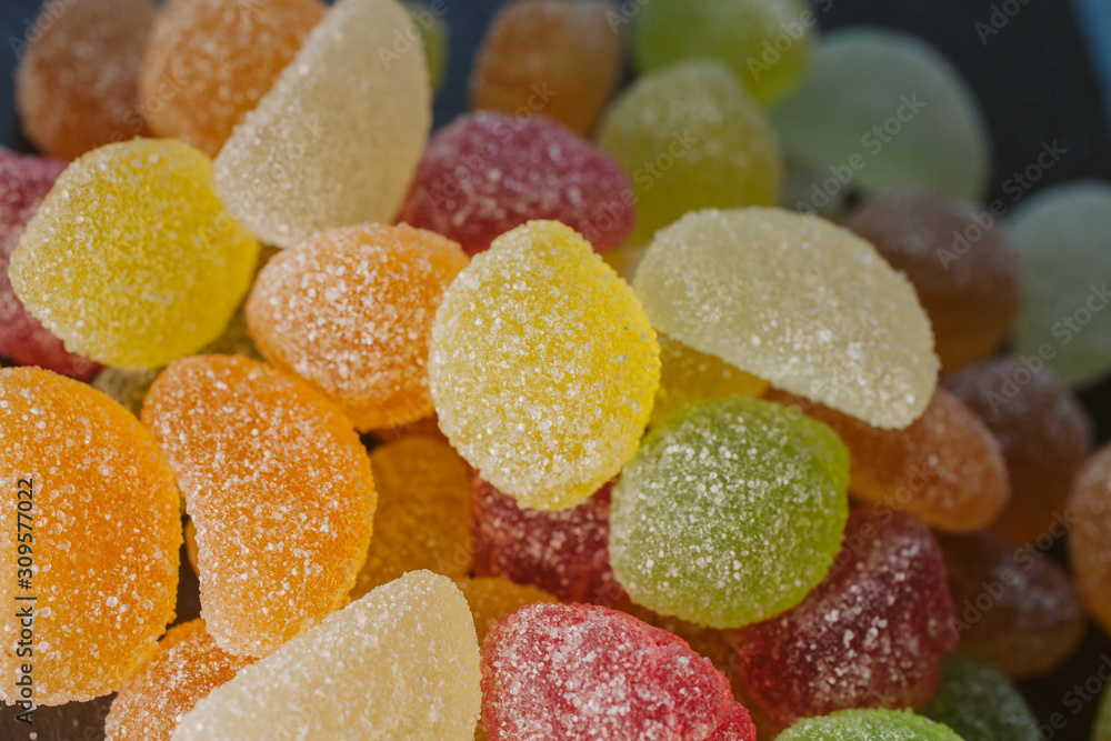 Colorful jelly candies with sugar. Close up view of fruity jelly candies as background. Sugar candies texture. Colorful jelly candies with sugar. Close up view of fruity jelly candies as background. Sugar candies texture.