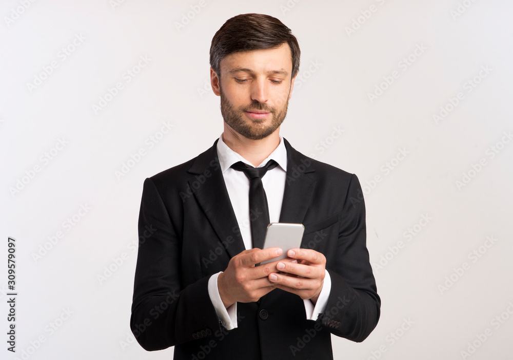 Man In Suit Using Phone Texting With Colleagues, White Background Man In Suit Using Phone Texting With Colleagues, White Background