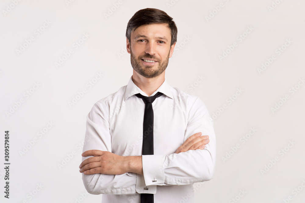 Positive Business Guy Smiling Crossing Hands Standing In Studio Positive Business Guy Smiling Crossing Hands Standing In Studio