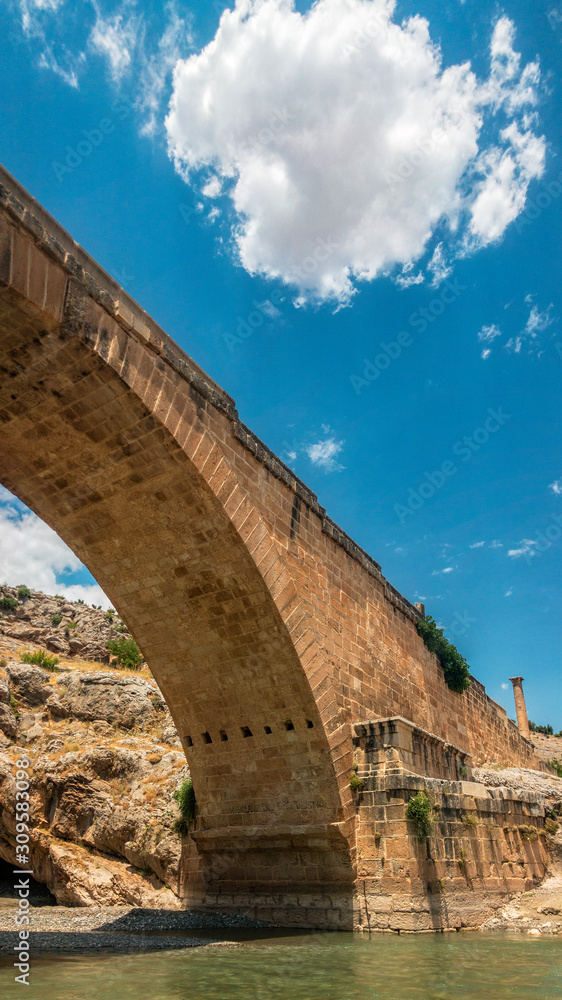 Panoramic view of the Severan Bridge, Cendere Koprusu is a late Roman bridge, close to Nemrut Dagi and Adiyaman, Turkey. Roadway flanked by ancient columns of Roman Emperor Lucius Septimius Severus