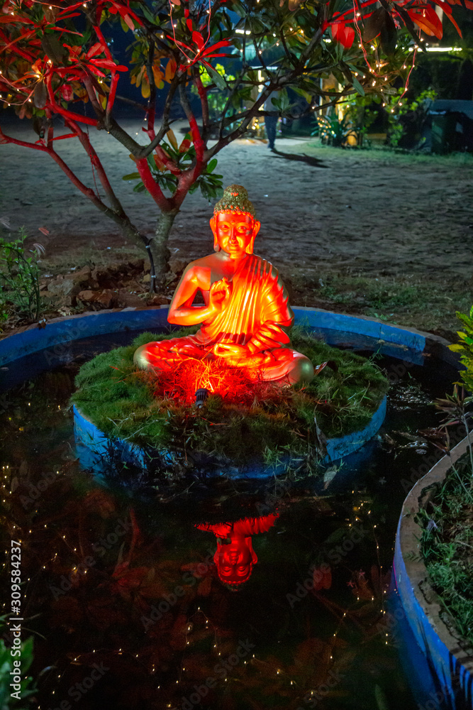 Fototapeta premium Beautiful Buddha statue in the night garden, Goa, India