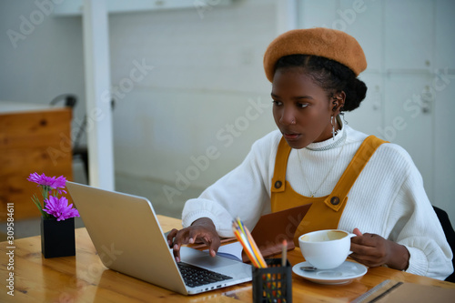 Wallpaper Mural African American business women are using laptops to work in the office - black people Torontodigital.ca