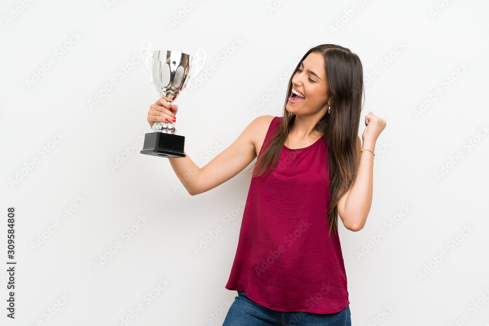 Young woman over isolated white background holding a trophy Young woman over isolated white background holding a trophy