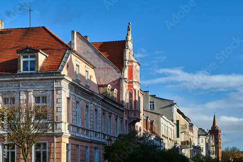 Street with historic tenements on a sunny day in Gniezno.