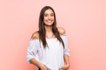 Young woman over isolated pink background laughing
