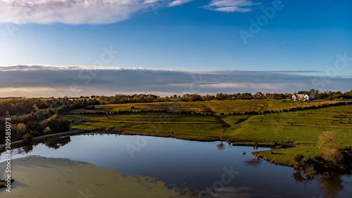 Fototapeta Naklejka Na Ścianę i Meble -  Morning over a rural countryside pond in Nebraska during autumn