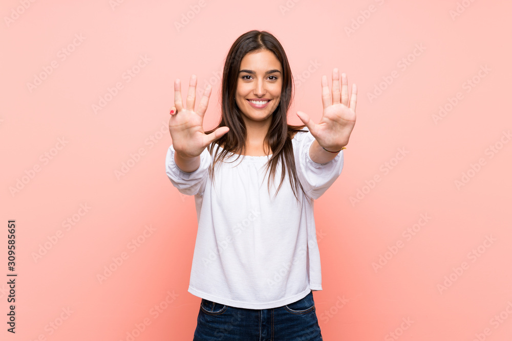 Young woman over isolated pink background counting nine with fingers Young woman over isolated pink background counting nine with fingers
