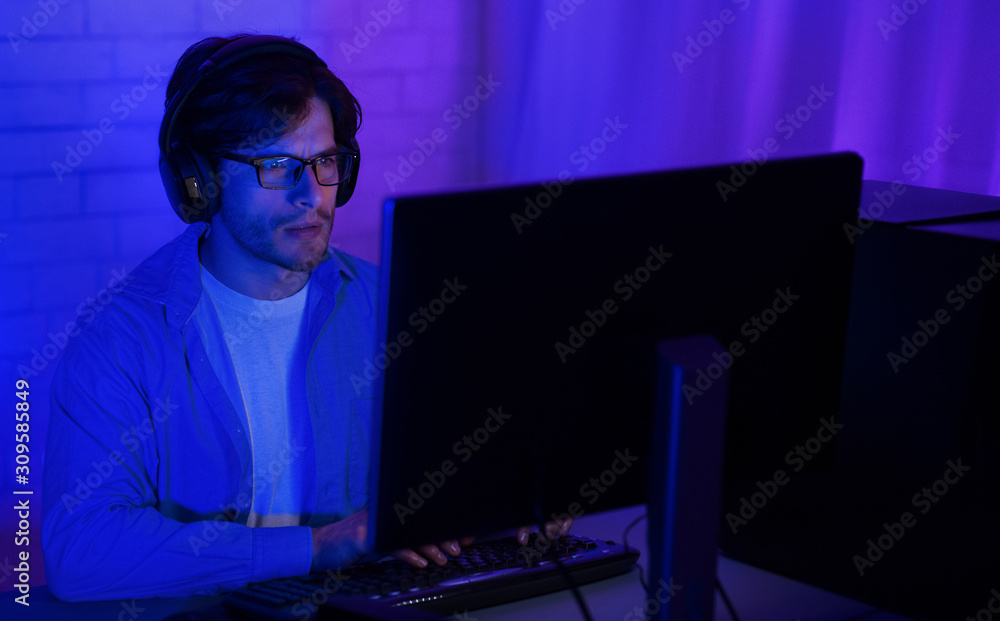 Man in front of computer, using pc late in night Man in front of computer, using pc late in night