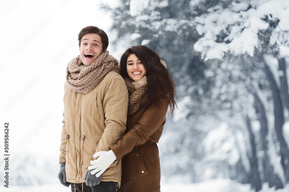 Husband And Wife Smiling At Camera Posing In Snowy Forest Husband And Wife Smiling At Camera Posing In Snowy Forest