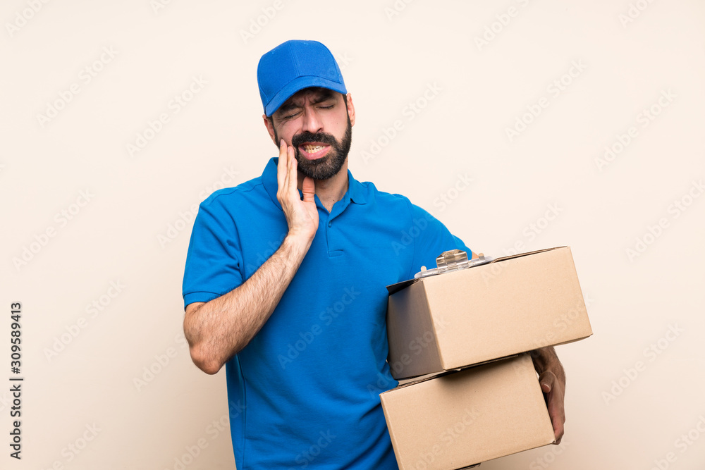 Delivery man with beard over isolated background with toothache Delivery man with beard over isolated background with toothache