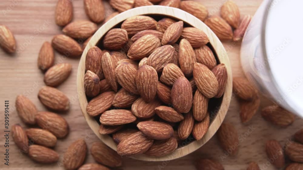 Top view of almond seeds in a wooden bowl Top view of almond seeds in a wooden bowl