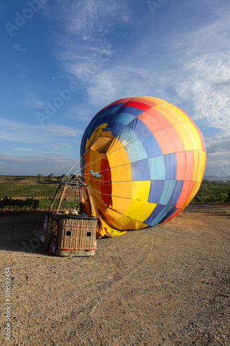 Colorful hot air balloon landed on the field
