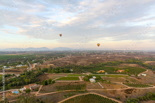 Hot air balloon fly over vine yards 