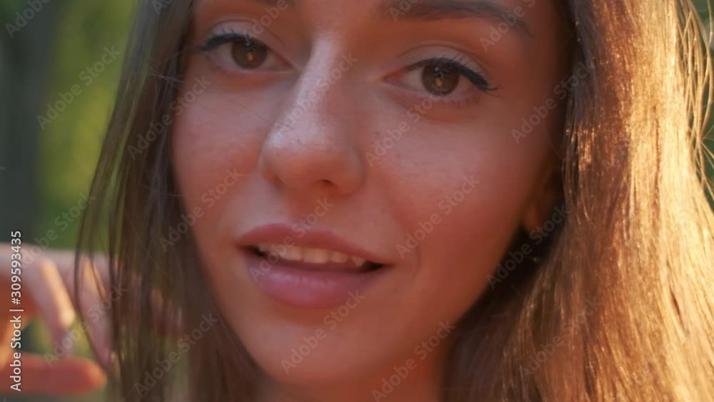 portrait of a beautiful brunette.the girl smiles.girl on nature.slow motion video portrait of a beautiful brunette.the girl smiles.girl on nature.slow motion video