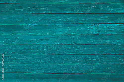 Green old wooden texture background. Scratched weathered blue wooden wall with peeled off paint close up. Horizontal wooden boards. Copy space