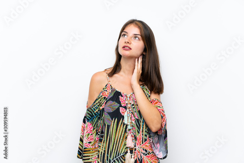 Caucasian young woman in colorful dress on isolated white background thinking an idea © luismolinero