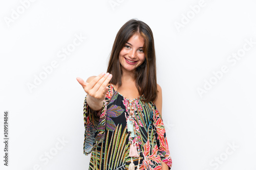 Caucasian young woman in colorful dress on isolated white background inviting to come