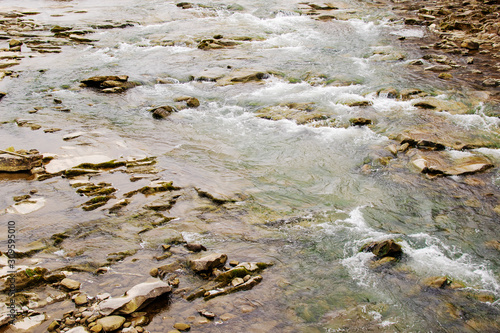 Beautiful Reshi River water flowing through stones and rocks at dawn, photo
