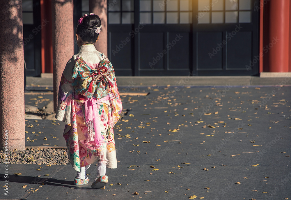  Girls wear kimonos as the national dress of Japan, walk in temples to go to festivities.