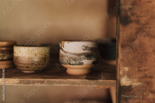 Clay pottery ceramic Products dry on shelf in workshop.