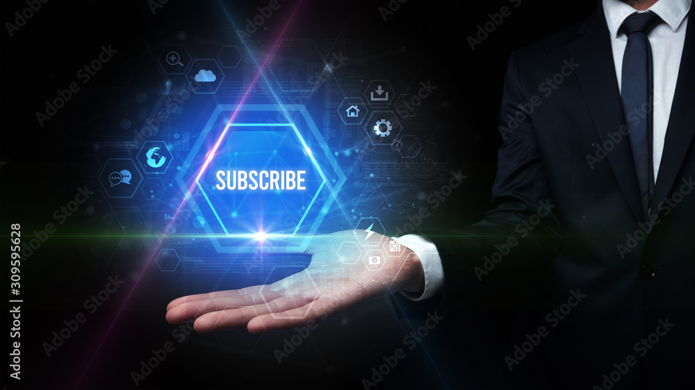 Man hand holding SUBSCRIBE inscription, social media concept Man hand holding SUBSCRIBE inscription, social media concept