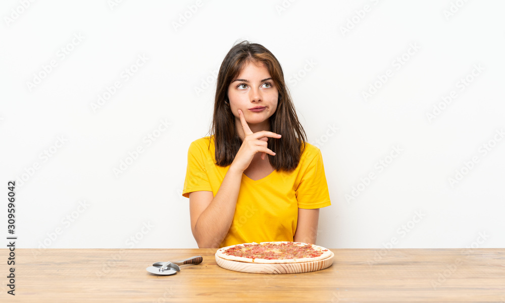 Caucasian girl with a pizza thinking an idea Caucasian girl with a pizza thinking an idea