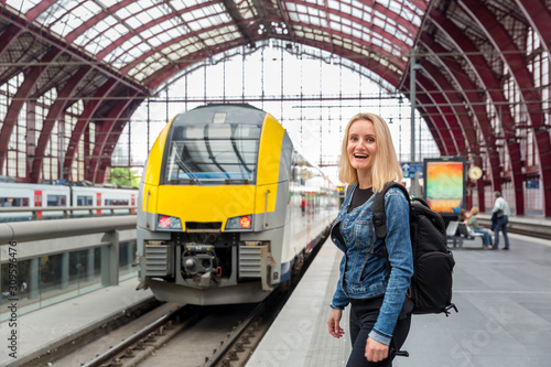 Female tourist on railway station platform, Europe