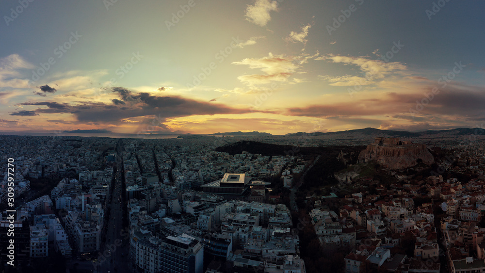 Aerial drone photo of Athens new modern Acropolis museum and urban cityscape at dusk with beautiful colours and cloudy sky, Attica, Greece