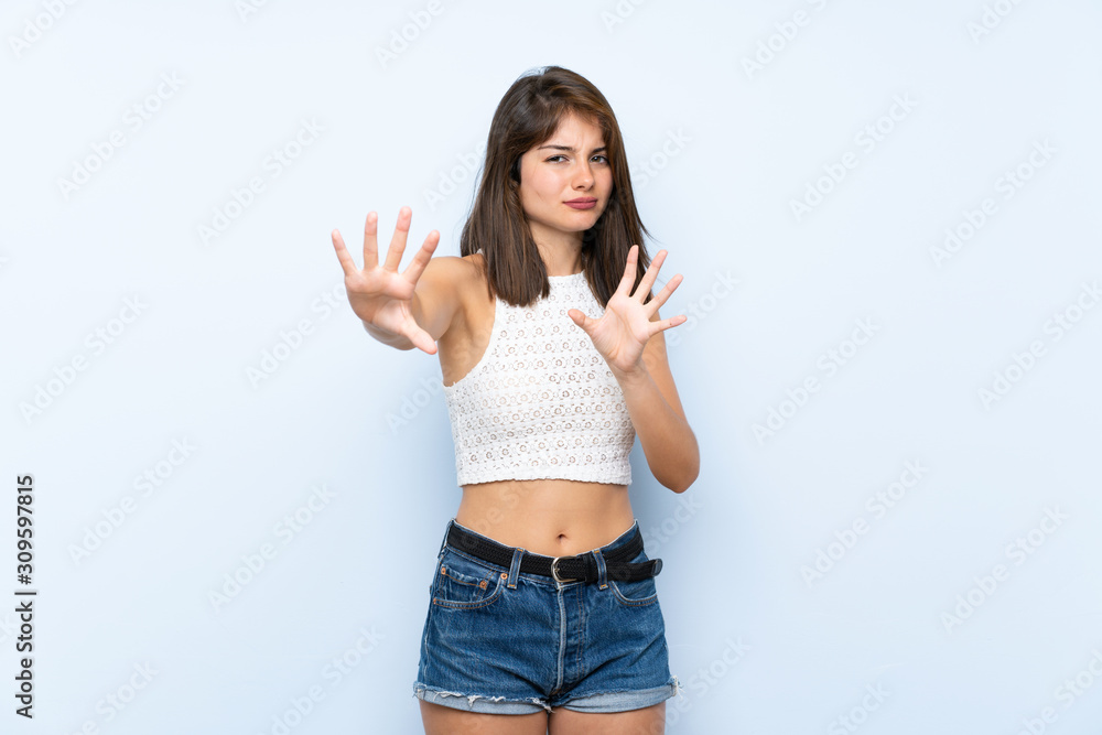 Young woman over isolated blue background nervous stretching hands to the front Young woman over isolated blue background nervous stretching hands to the front