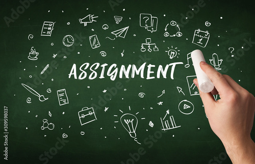 Hand drawing ASSIGNMENT inscription with white chalk on blackboard, education concept