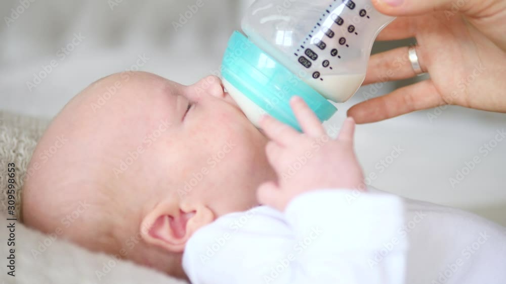 Mother Feeding Her Baby boy with A Bottle. Mother Feeding Her Baby boy with A Bottle.