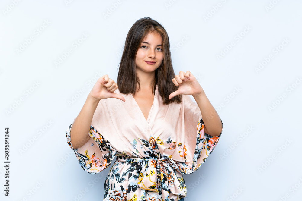 Caucasian girl with kimono over isolated blue background proud and self-satisfied Caucasian girl with kimono over isolated blue background proud and self-satisfied
