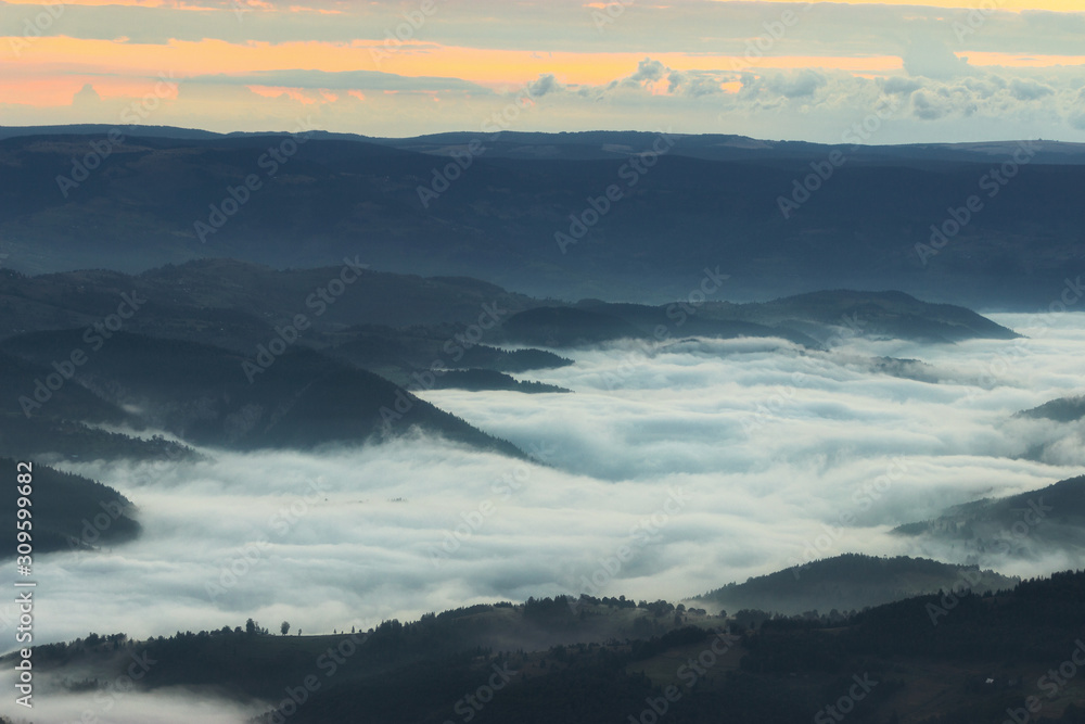 Sunrise mountain landscape misty valley.  