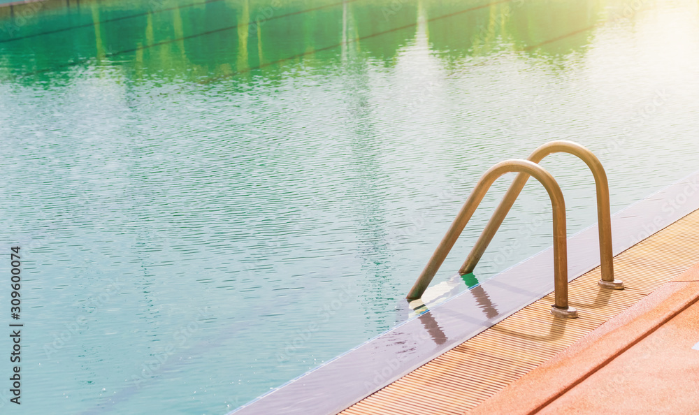 Obraz premium Swimming pool with stair and wooden deck at hotel.