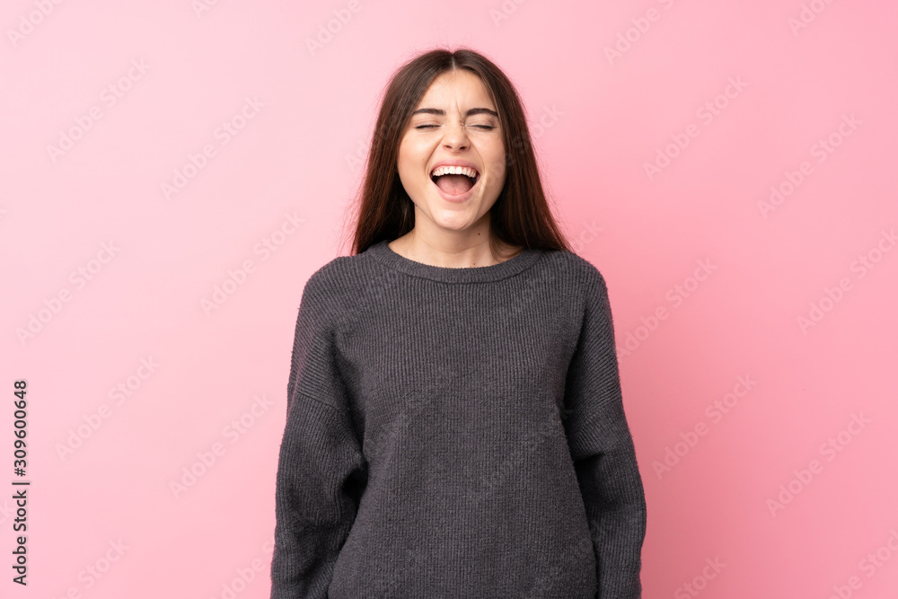 Young woman over isolated pink background shouting to the front with mouth wide open Young woman over isolated pink background shouting to the front with mouth wide open