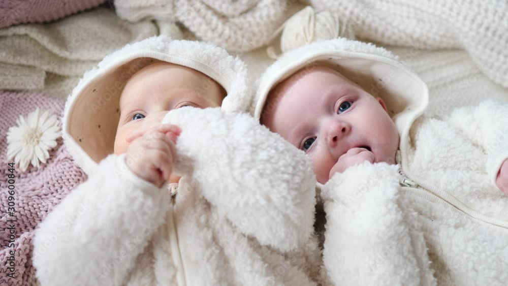 Baby Girl Twins Lying On Bed At Home Together. Baby Girl Twins Lying On Bed At Home Together.