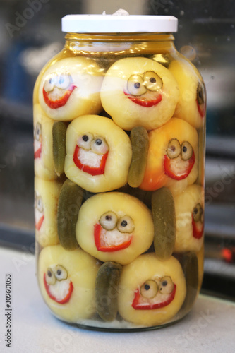 Funny preserves vegetables in glass jars. © acceptfoto