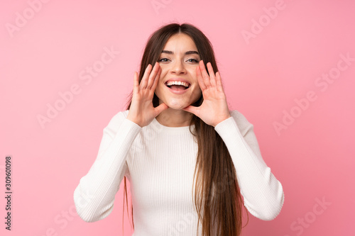 Fotótapéta Young woman over isolated pink background shouting with mouth wide open