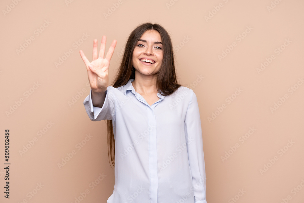 Young woman over isolated background happy and counting four with fingers Young woman over isolated background happy and counting four with fingers
