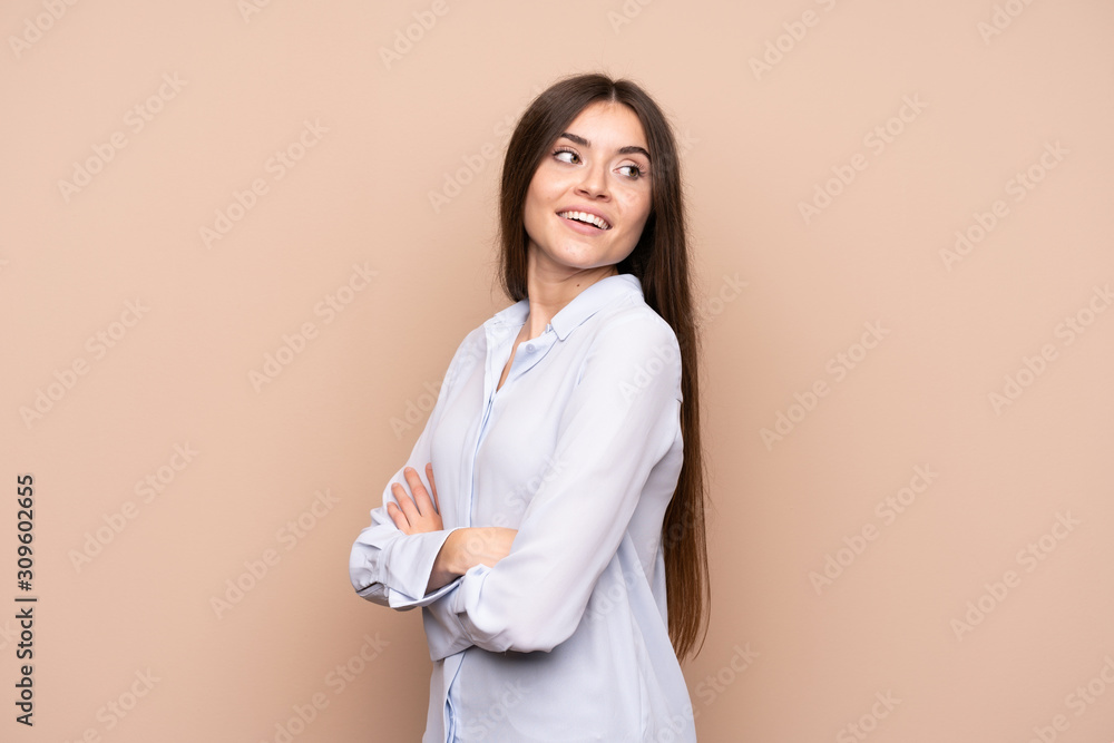 Young woman over isolated background with arms crossed and happy Young woman over isolated background with arms crossed and happy
