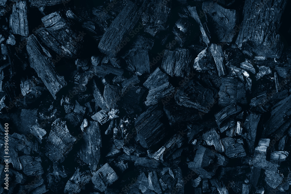 Black charcoal texture abstract surface background. Top view. Color of the year 2020 classic blue toned