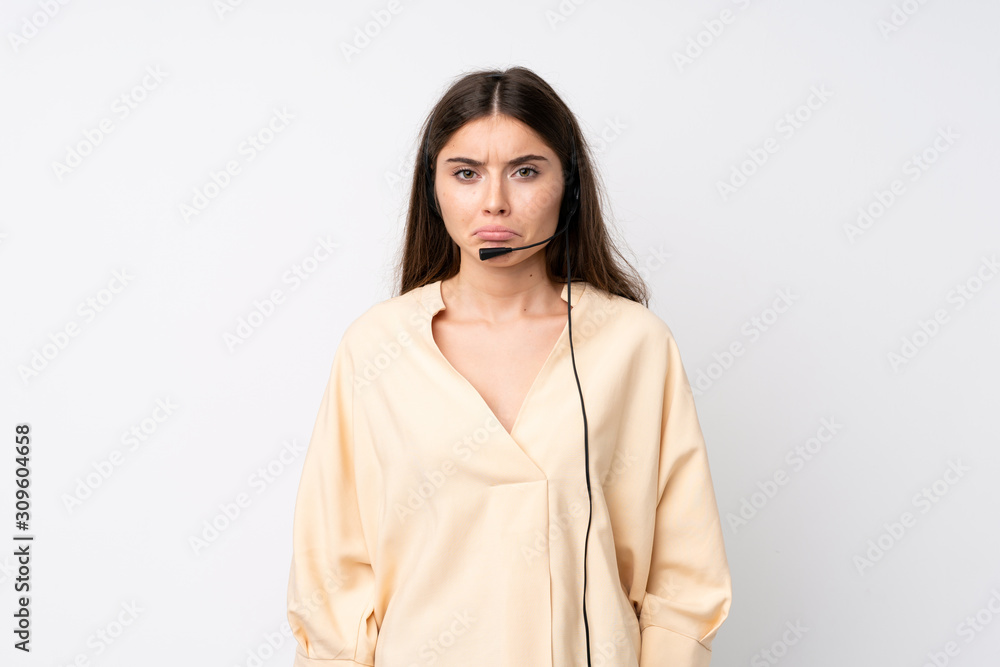 Young telemarketer woman over isolated white background sad Young telemarketer woman over isolated white background sad