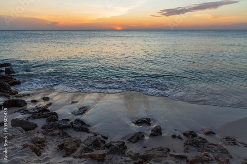 Amazing sunset on Eagle Beach of Aruba Island. Unforgettable view. Beautiful nature landscape.