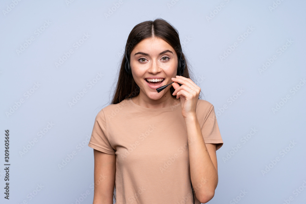 Young woman over isolated blue background working with headset Young woman over isolated blue background working with headset