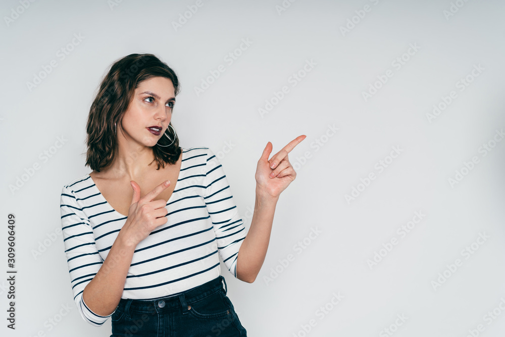 Serious woman pointing up with fingers Serious woman pointing up with fingers