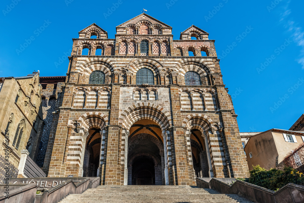 The facade of Le Puy Cathedral in Le Puy-en-Velay town. Haute-Loir department, Auvergne-Rhone-Alpes region in France.