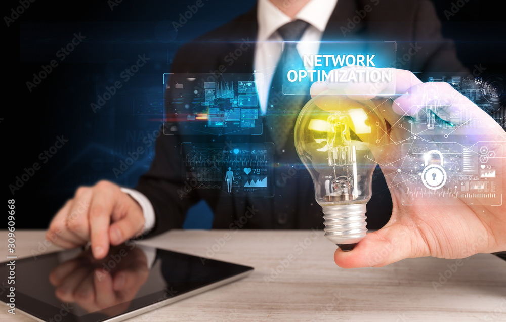 Businessman holding lightbulb with NETWORK OPTIMIZATION inscription, online security idea concept Businessman holding lightbulb with NETWORK OPTIMIZATION inscription, online security idea concept