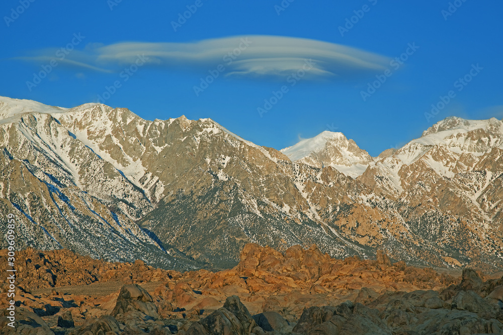 Lenticular cloud floats above the Eastern Sierra Nevada Mountains and Alabama Hills, Lone Pine, California, USA