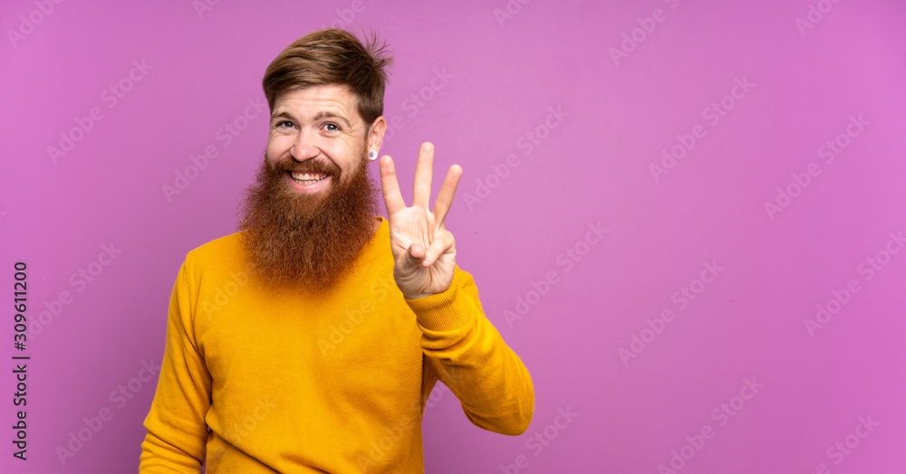 Redhead man with long beard over isolated purple background happy and counting three with fingers Redhead man with long beard over isolated purple background happy and counting three with fingers
