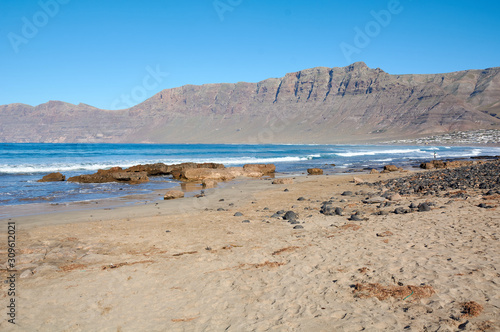 Playa de Famara beach, Canary Islands. Lanzarote, volcanic island. The magnificent coast of the Atlantic Ocean. February 2019.